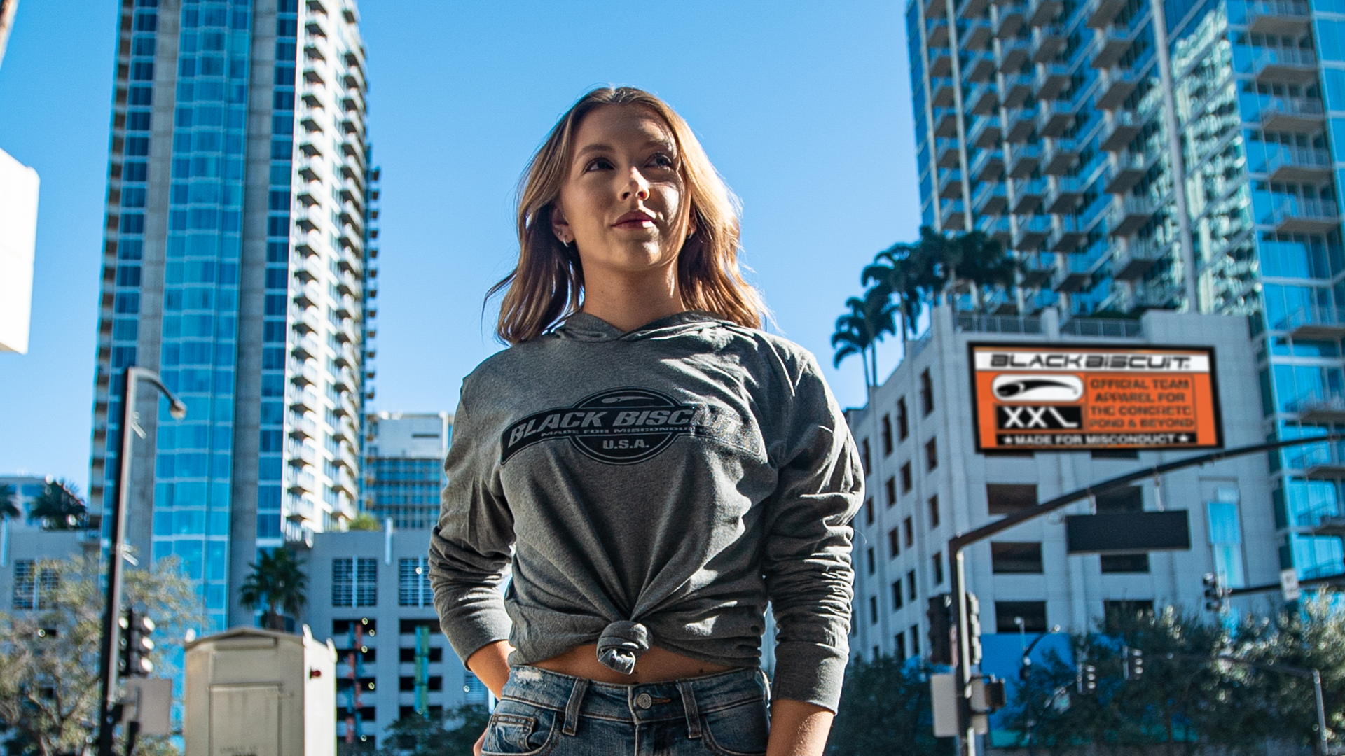 A woman in the city wearing a Black Biscuit hoodie