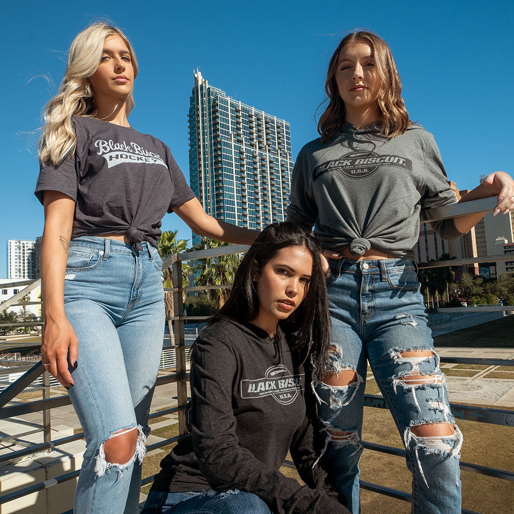 Three women wearing Black Biscuit shirts