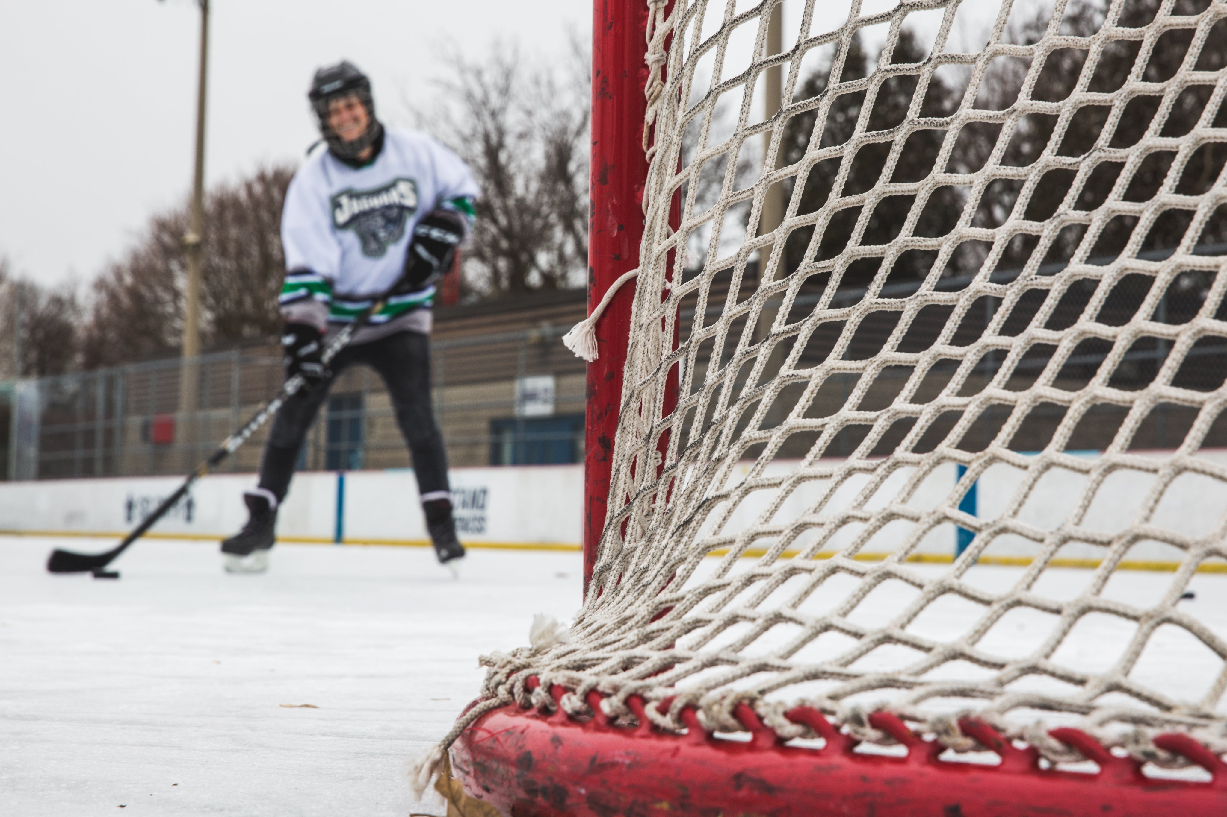 Closeup shot of the side of a hockey net as a player prepares to shoot